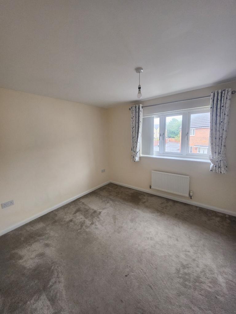 Bright upstairs bedroom with a large window, ne...