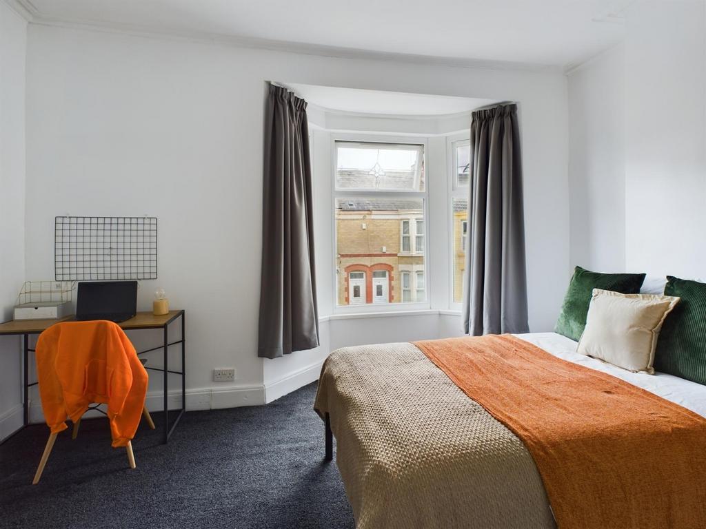 A bright and inviting double bedroom with ample...