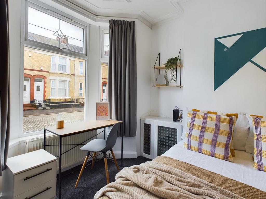 A bright and stylish double bedroom featuring m...