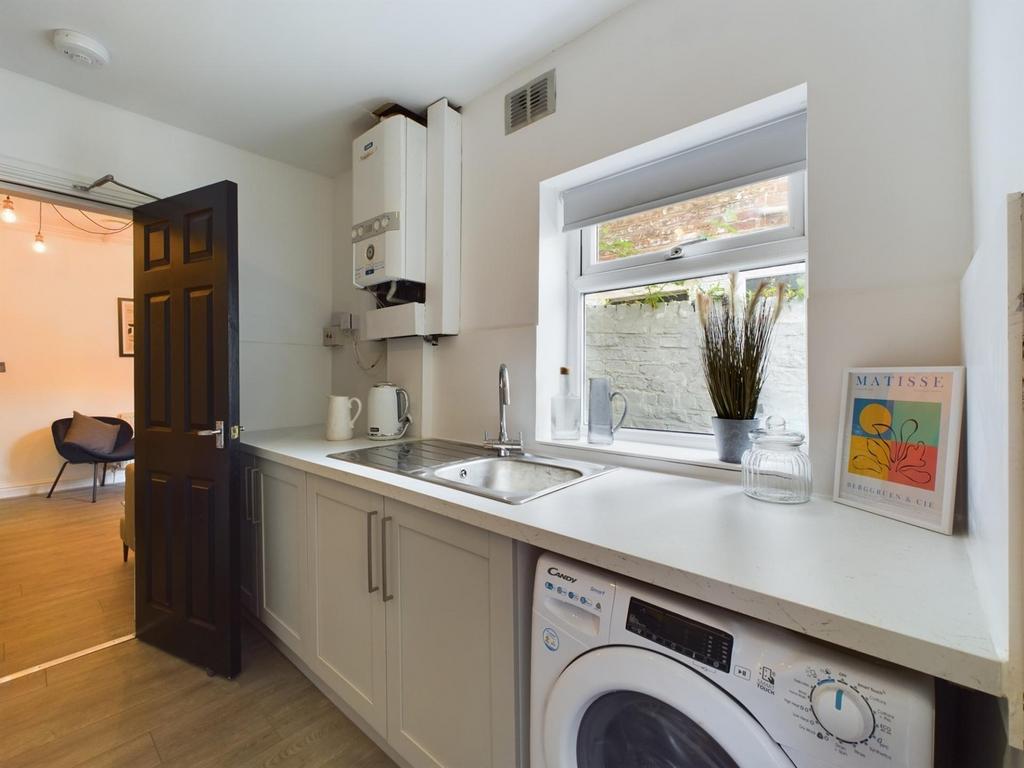 A modern kitchenette featuring bright natural l...