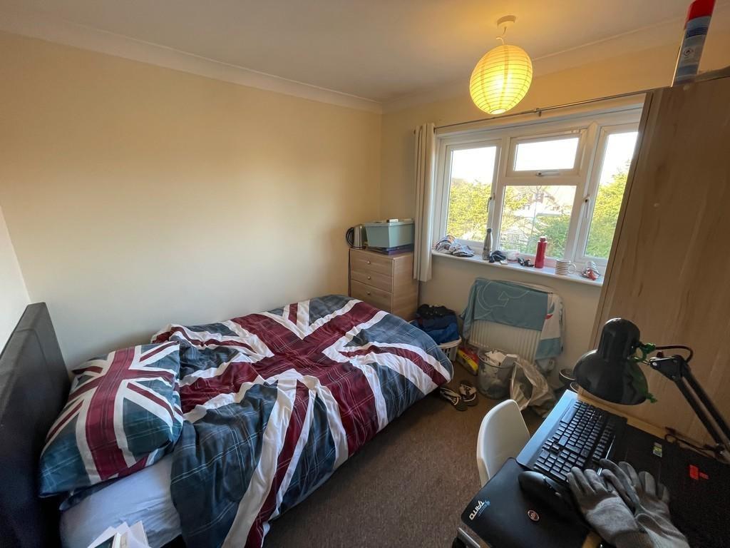 A cozy bedroom featuring a bed with a Union Jac...