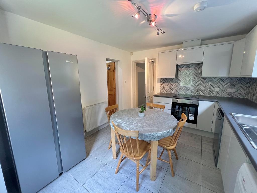 A bright and modern kitchen featuring a spaciou...