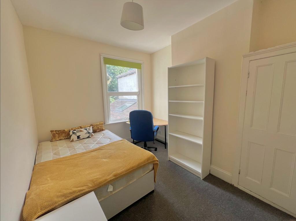 A bright and inviting double bedroom featuring ...