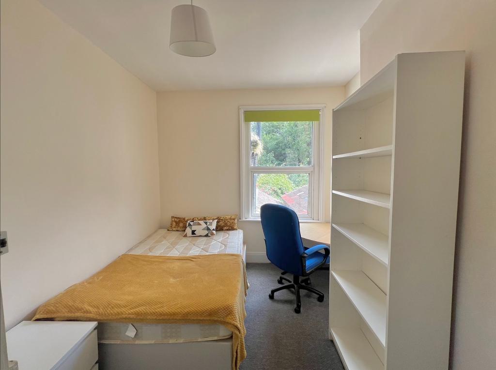 A cozy and inviting double bedroom featuring am...
