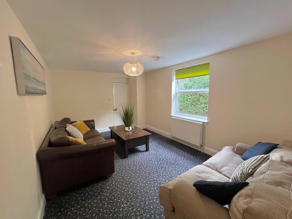 A spacious and inviting living room with modern...