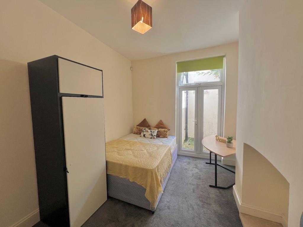 A bright and inviting double bedroom featuring ...