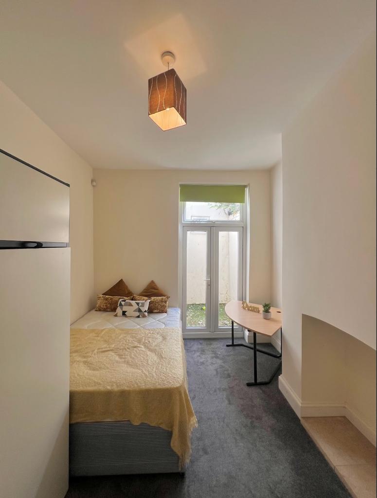 A bright and inviting double bedroom featuring ...