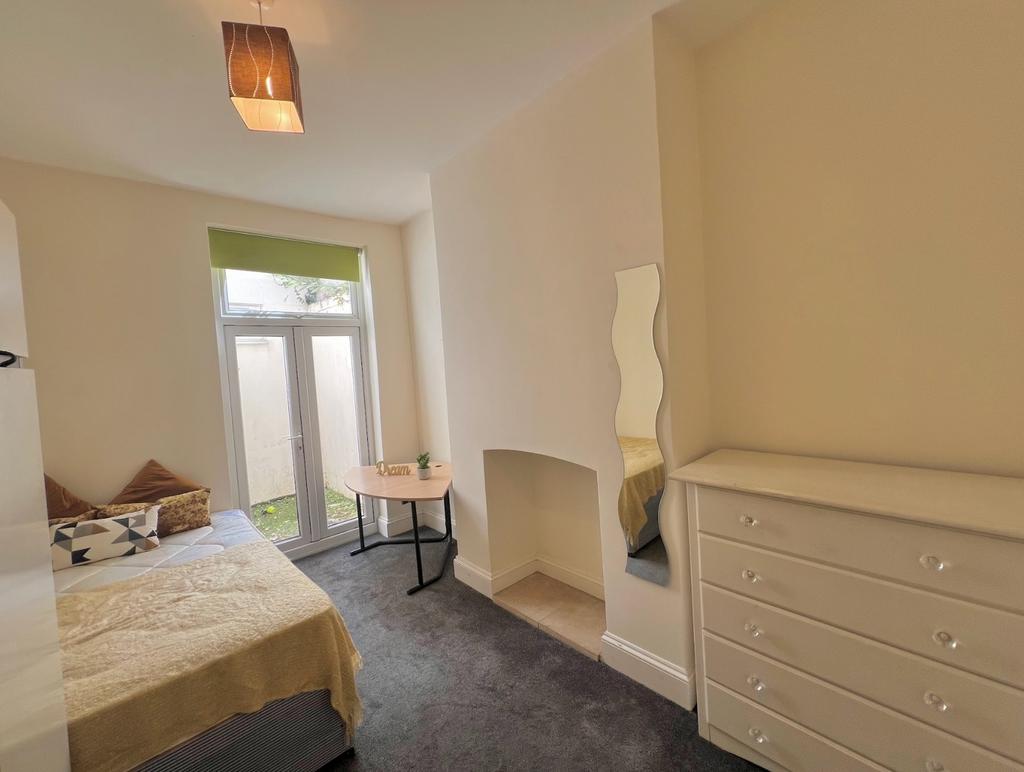 A bright and inviting double bedroom, featuring...
