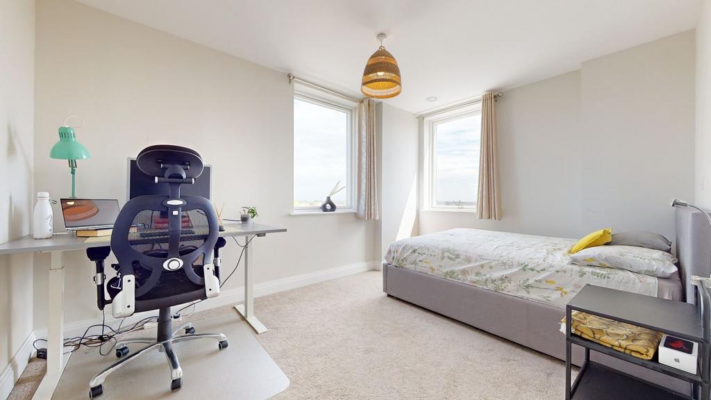 Bright, modern double bedroom with a comfortabl...
