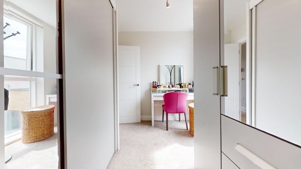 Bright, modern bedroom with built-in storage an...