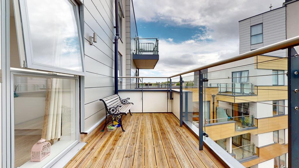 Bright modern balcony with timber decking, glas...