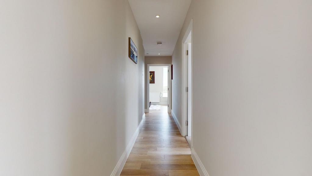 Bright, well-maintained hallway with wood-effec...