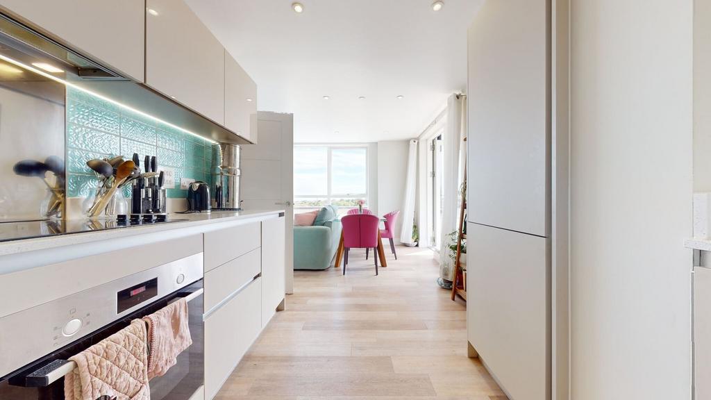 Bright, modern kitchen with sleek white cabinet...