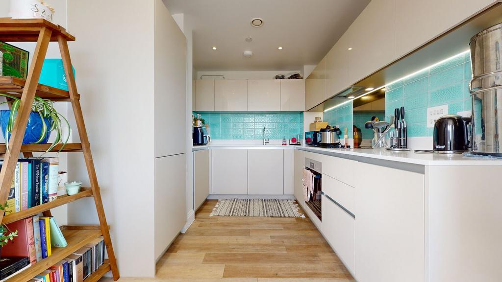 Bright modern kitchen with sleek white cabinetr...