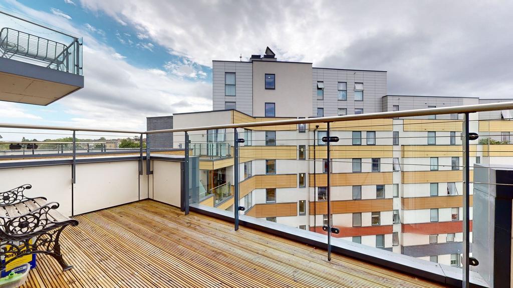 Spacious modern balcony with timber decking, gl...