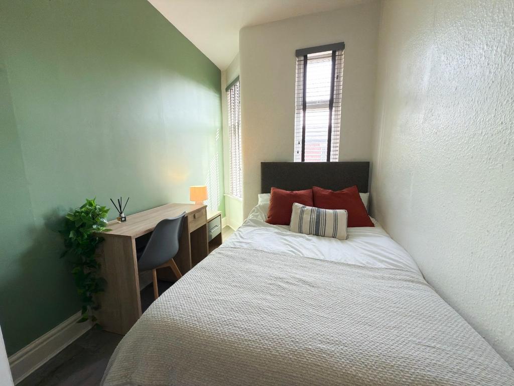 Bright, tidy bedroom with a comfortable bed, si...