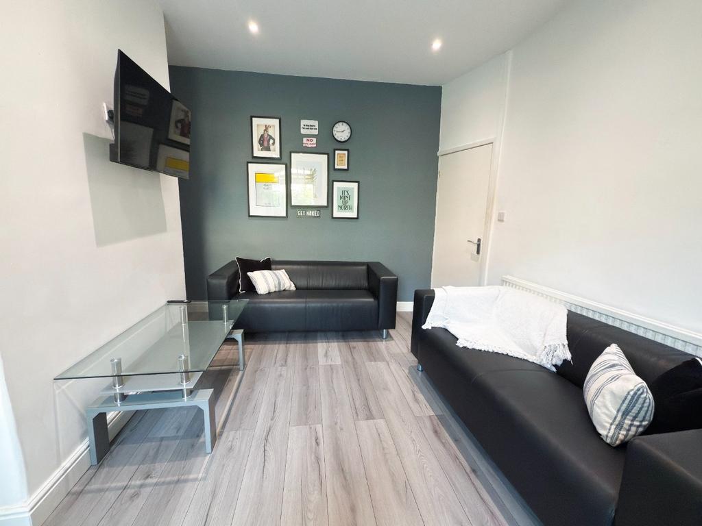 Modern furnished living room with two black sof...