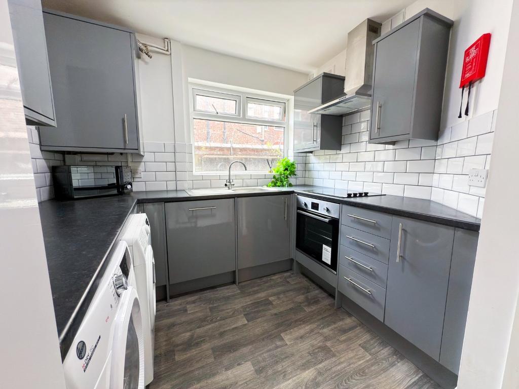Bright modern kitchen with grey cabinetry, inte...