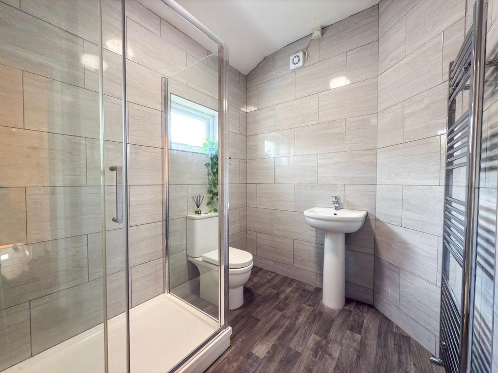 Modern tiled bathroom with a walk-in glass show...