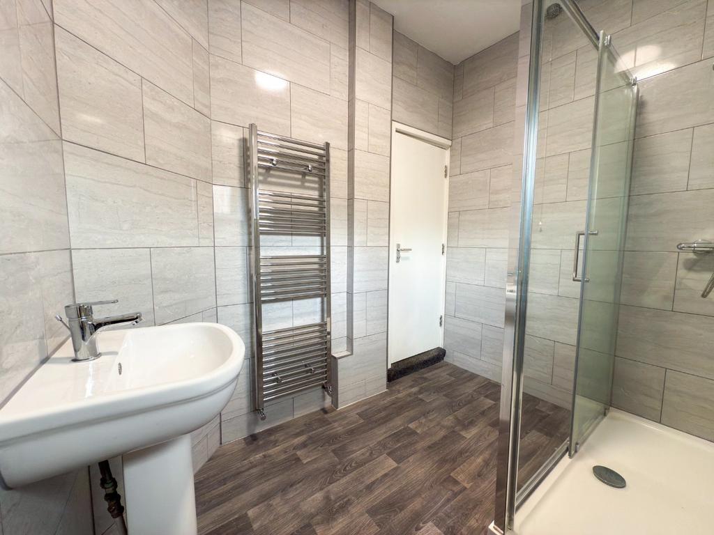 Modern bathroom with large walk-in shower, pede...