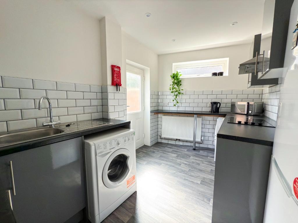 Bright modern kitchen with white subway tile sp...