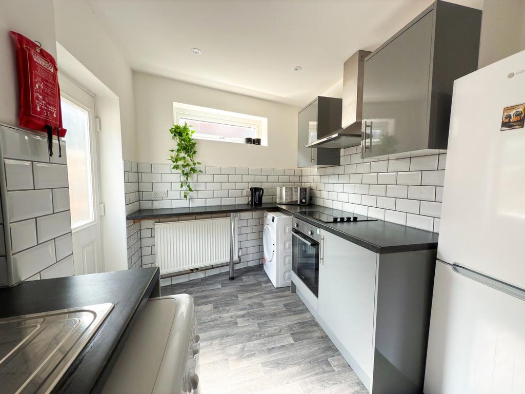 Bright modern kitchen with slate-coloured workt...