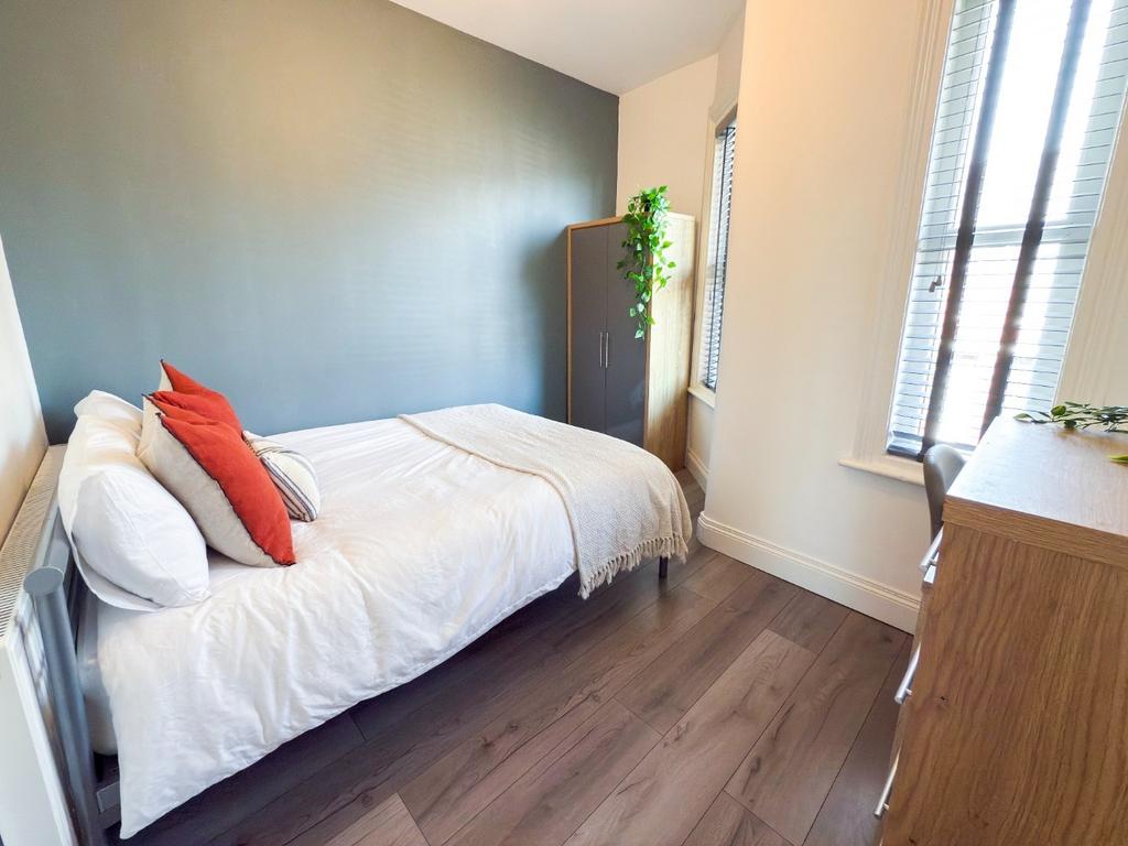 Bright, neatly presented bedroom with a double ...