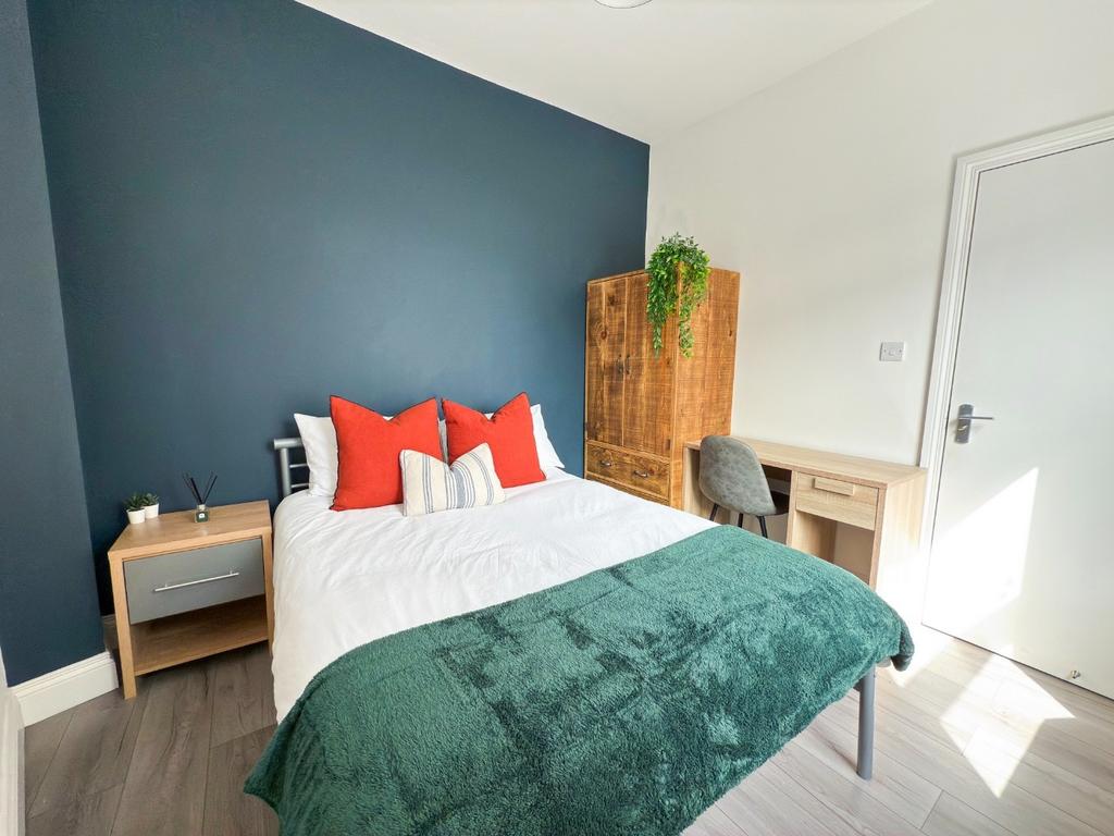 Bright, neatly presented bedroom with a double ...