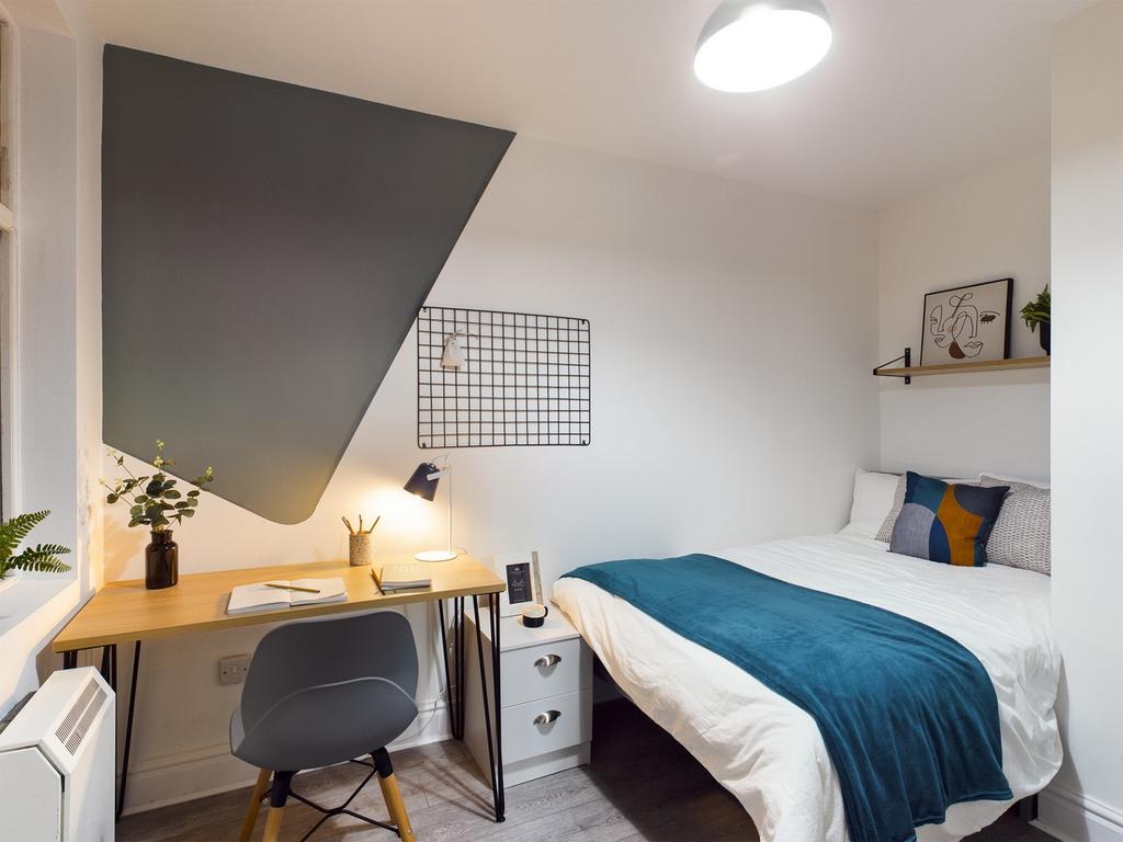 A bright and inviting double bedroom featuring ...