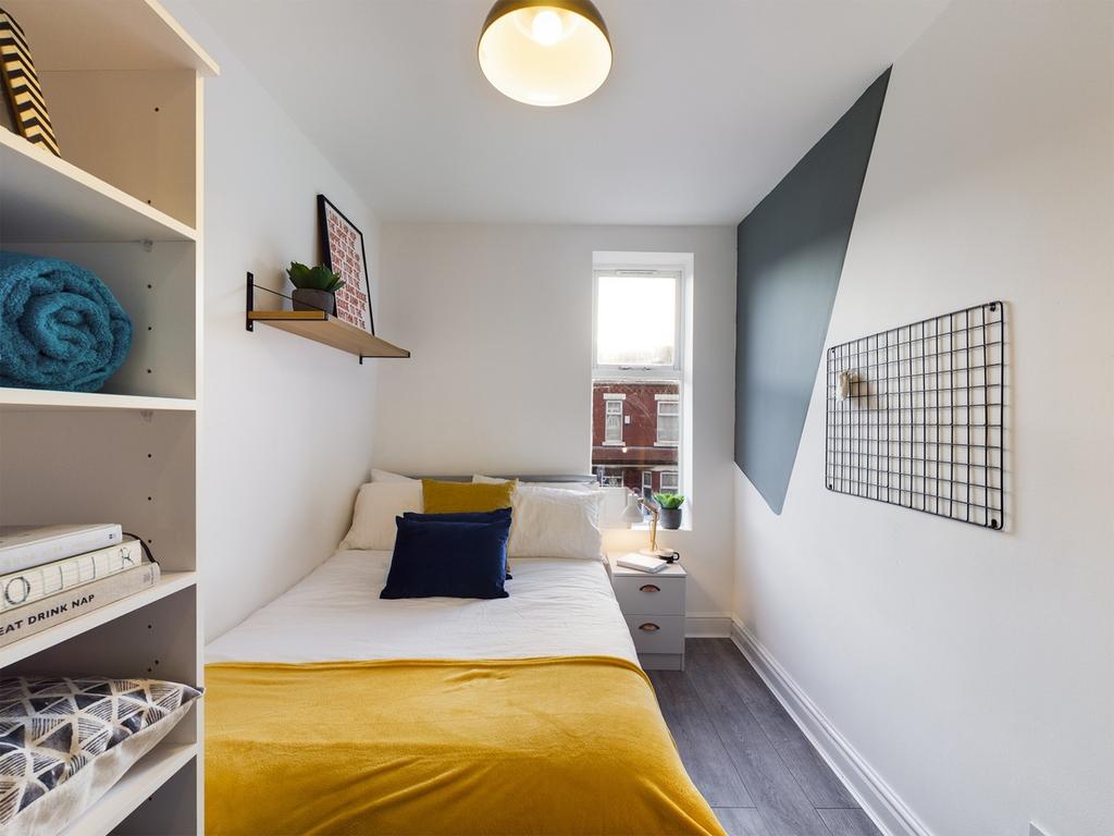 A bright and inviting double bedroom featuring ...