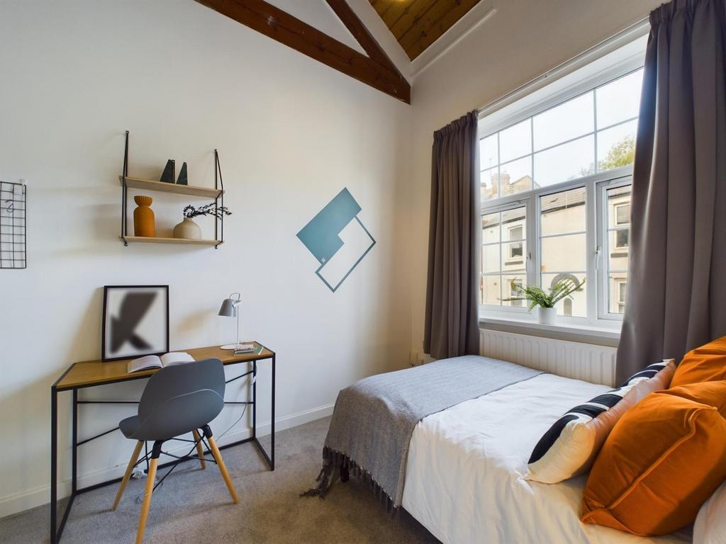 A bright and inviting double bedroom featuring ...