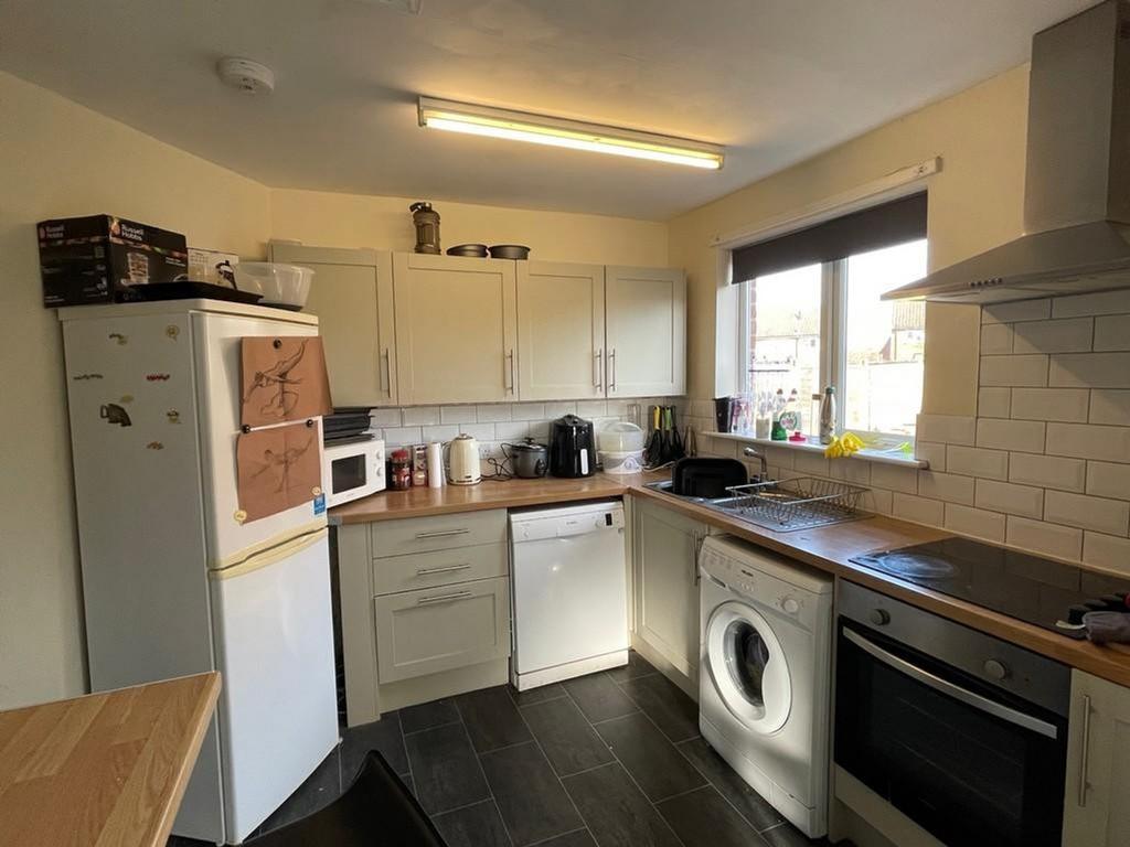 A bright and tidy kitchen featuring modern appl...