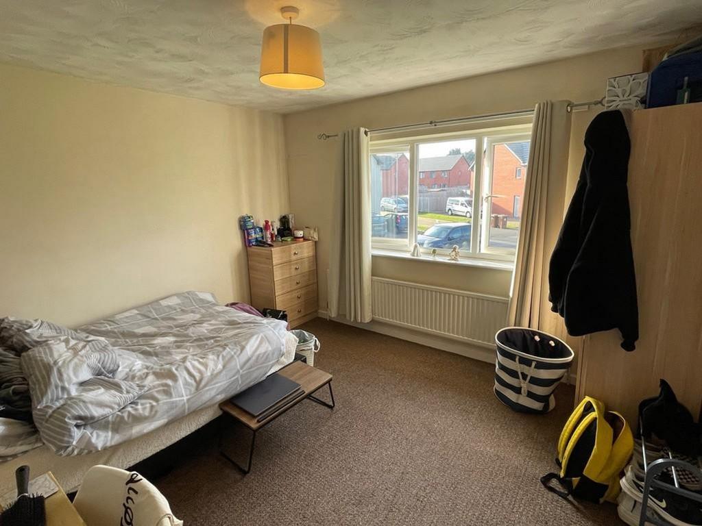 A spacious double bedroom with good natural lig...
