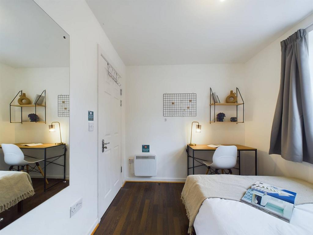 Bright, neatly presented bedroom with a comfort...
