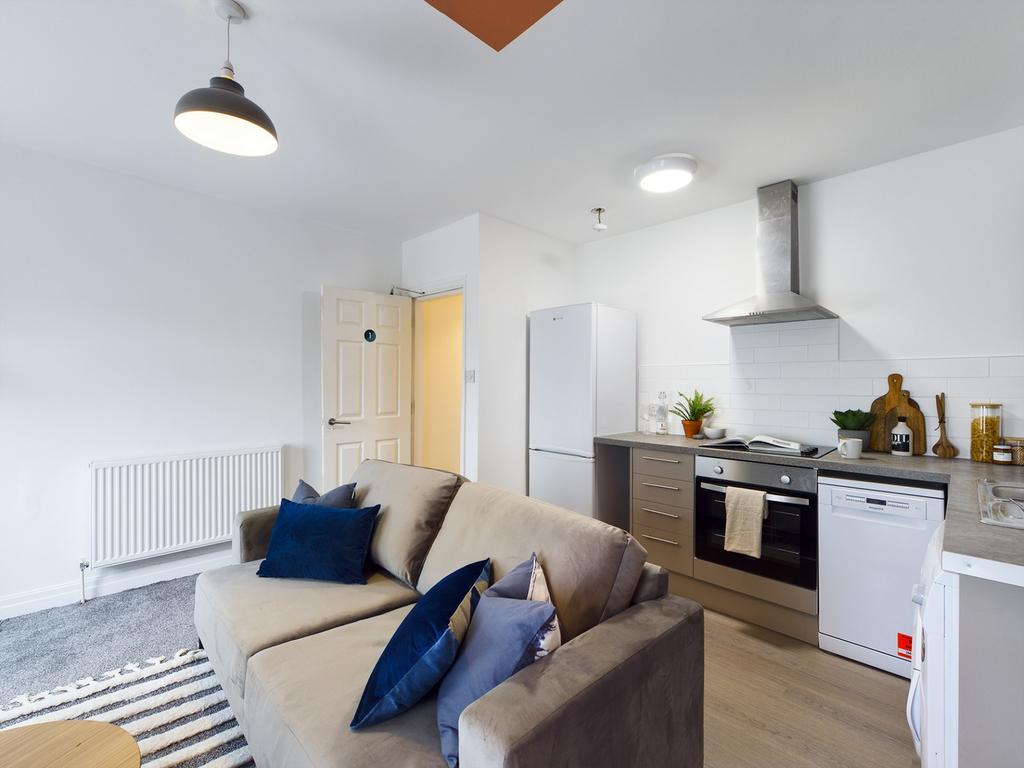 A bright and modern kitchenette with stylish de...