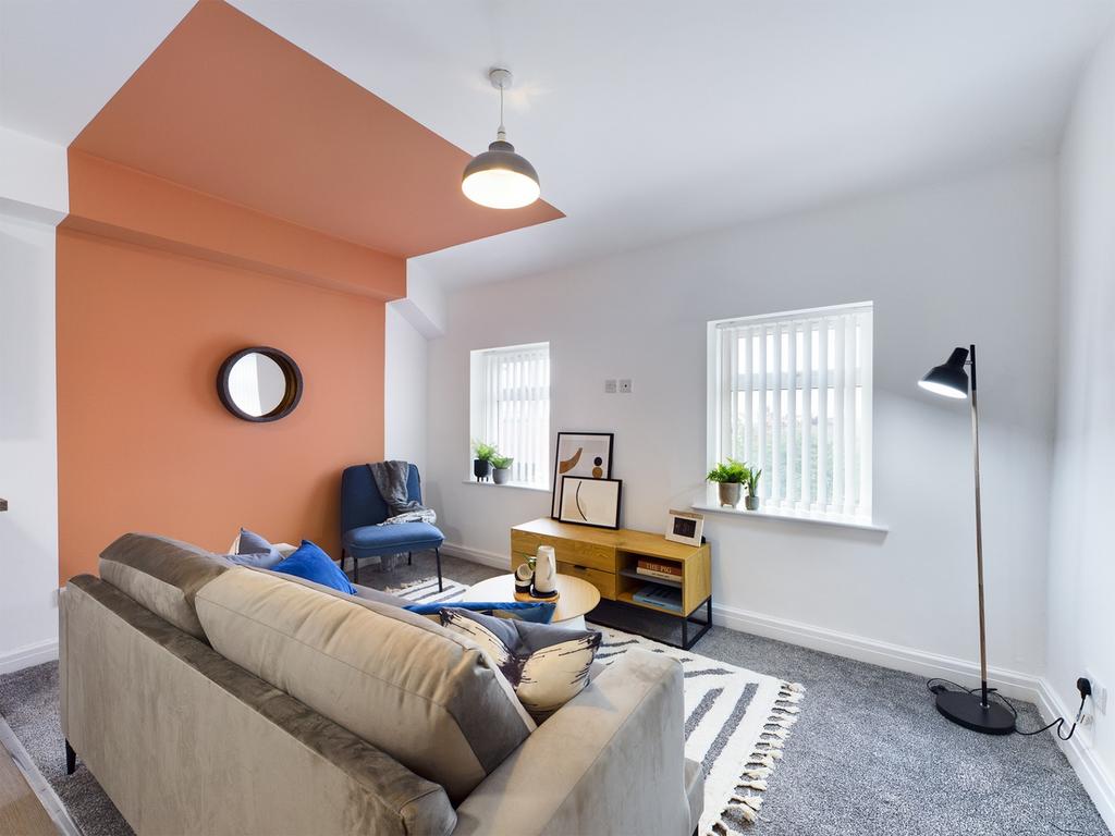 A spacious and modern living room filled with n...