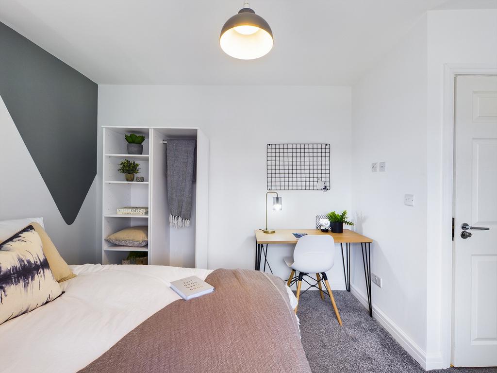 A stylish and well-lit double bedroom featuring...