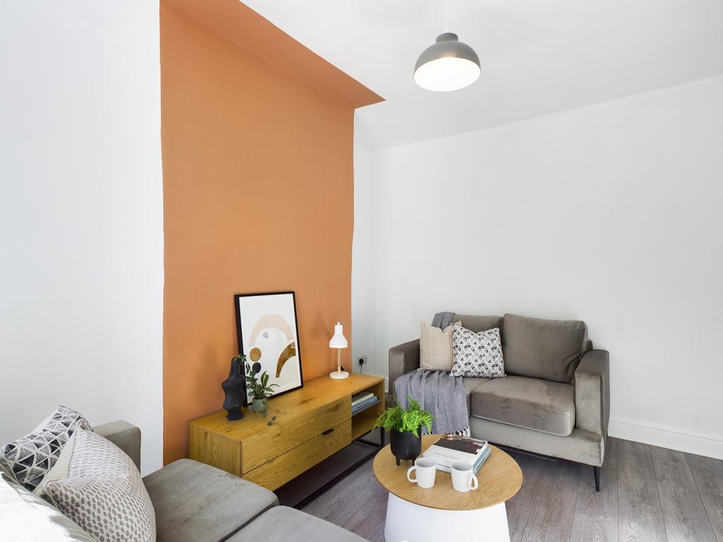 A bright and welcoming living room featuring a ...