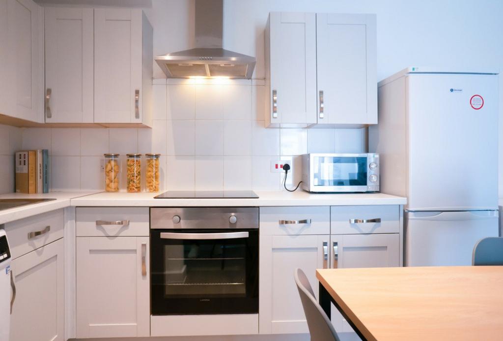 A modern kitchen featuring sleek cabinetry, a b...