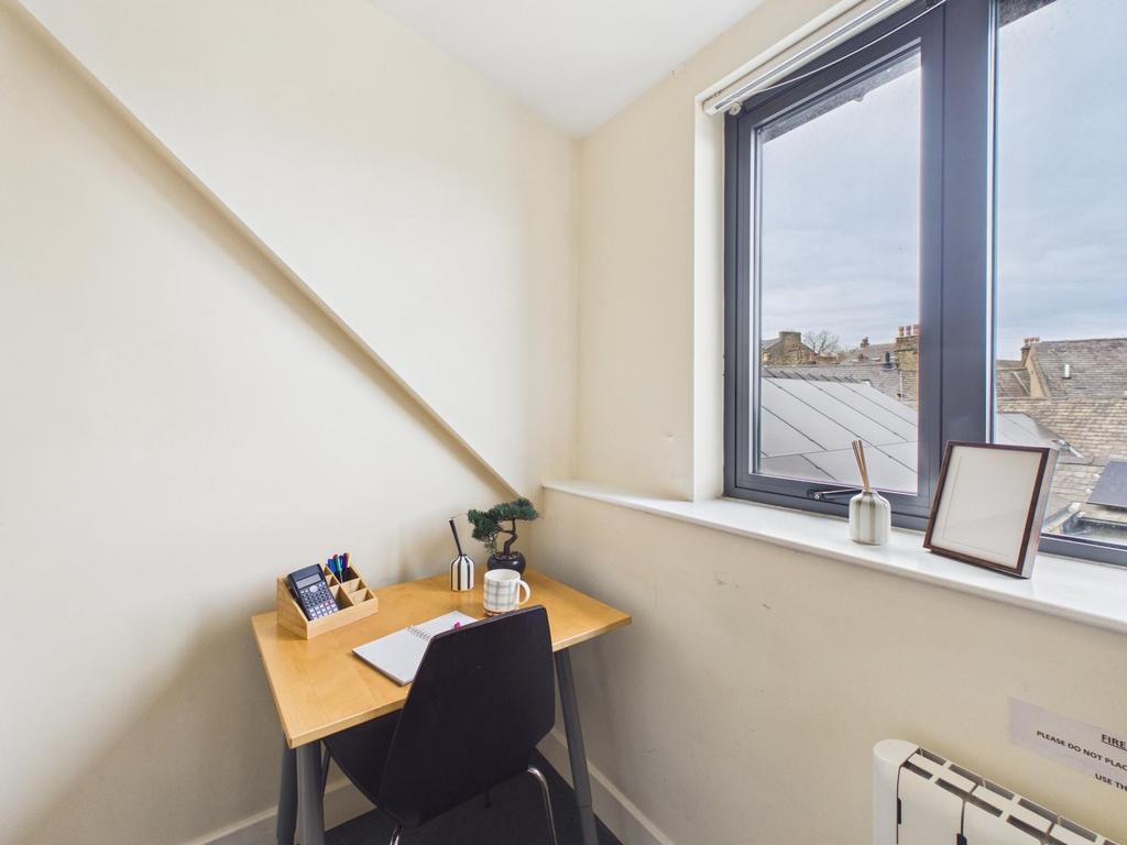 Bright small study nook with a large window off...