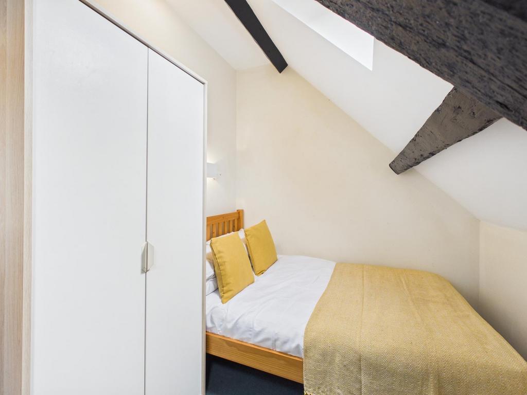 Cozy attic double bedroom with a neatly made be...