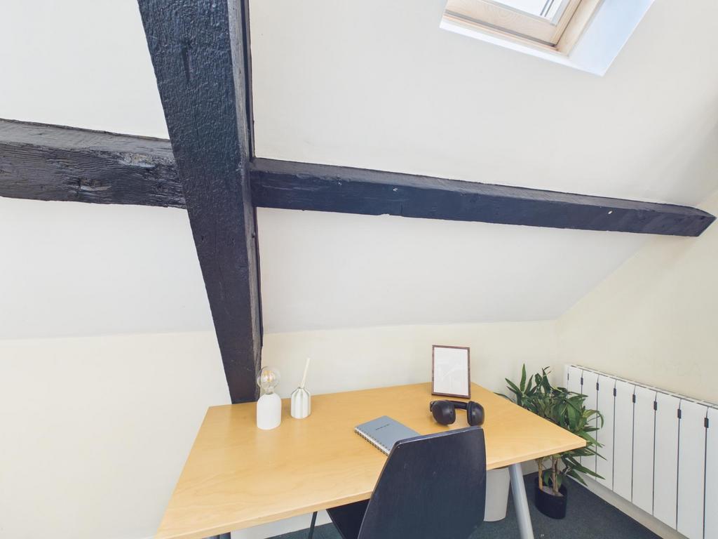 Bright loft workspace with exposed dark wooden ...
