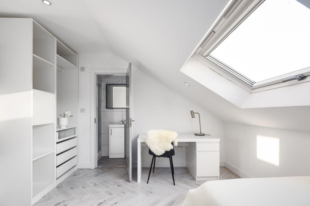 Bright and modern bedroom with a large skylight...