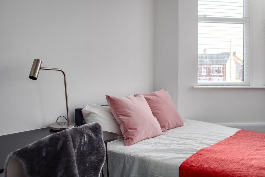 A modern, neatly made bedroom featuring a comfo...