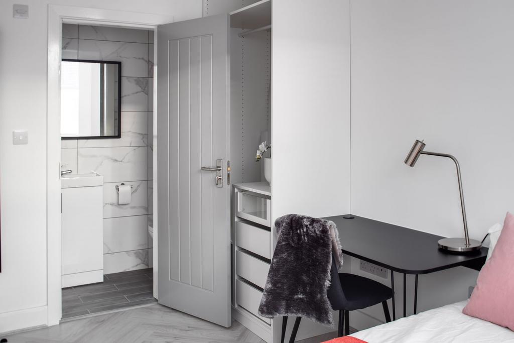 Modern bathroom featuring a sleek white vanity ...