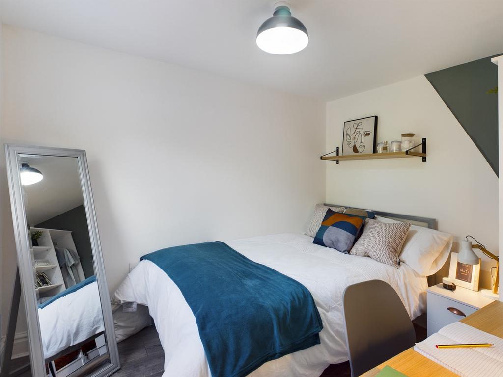 A bright and inviting double bedroom featuring ...