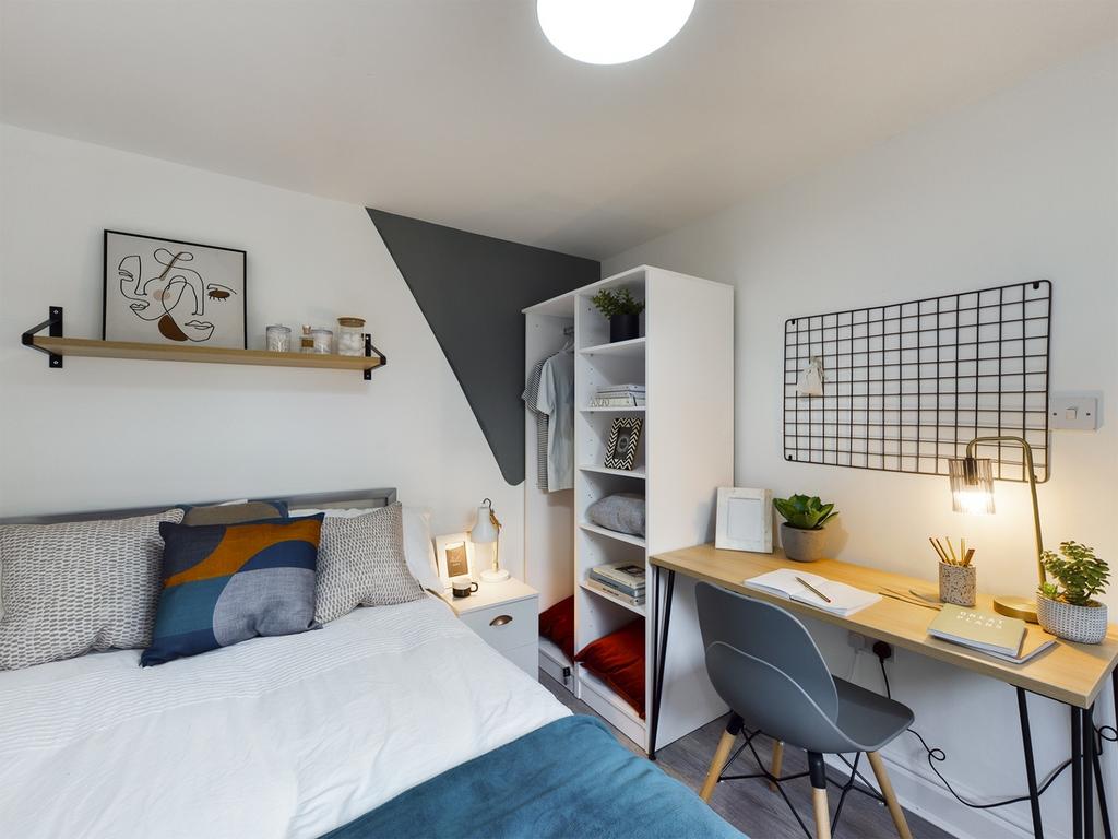 A bright and inviting double bedroom featuring ...