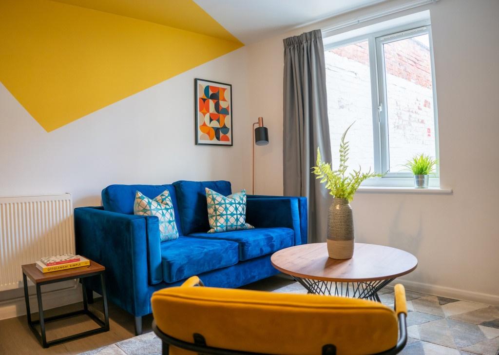A modern, well-lit living room featuring a vibr...