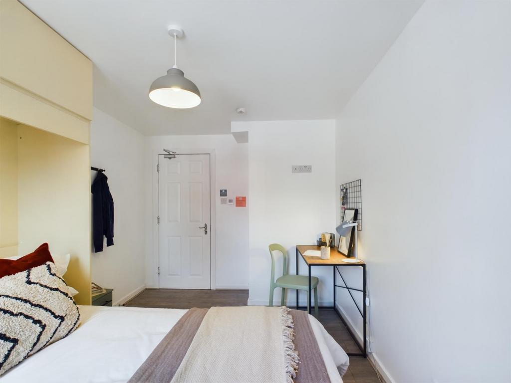 A basic and clean single toilet with a white to...