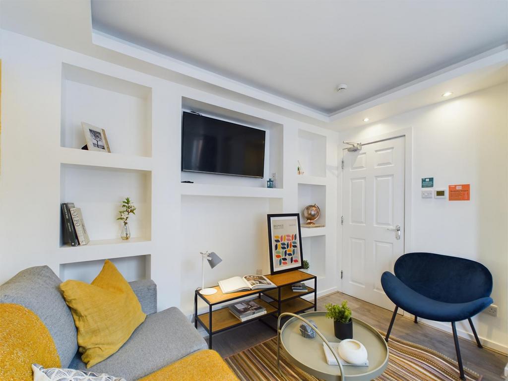 A modern, well-lit living room featuring a comf...